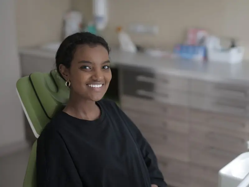 Young woman smiling while seated in a dental chair
